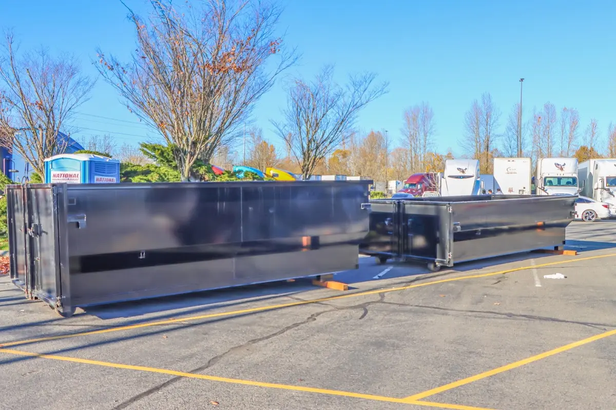 Professional dumpster rental service with roll-off container on residential driveway in Meriden